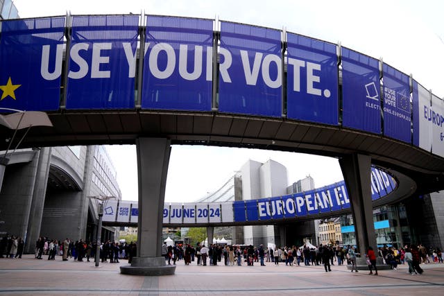 People wait in line to visit the European Parliament  