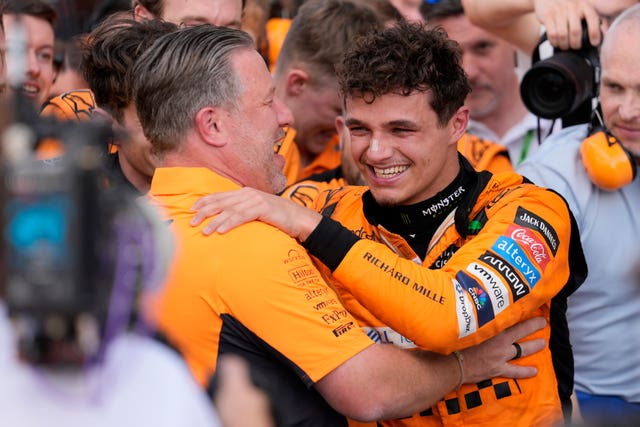 McLaren CEO Zak Brown, left, hugs Norris after the race