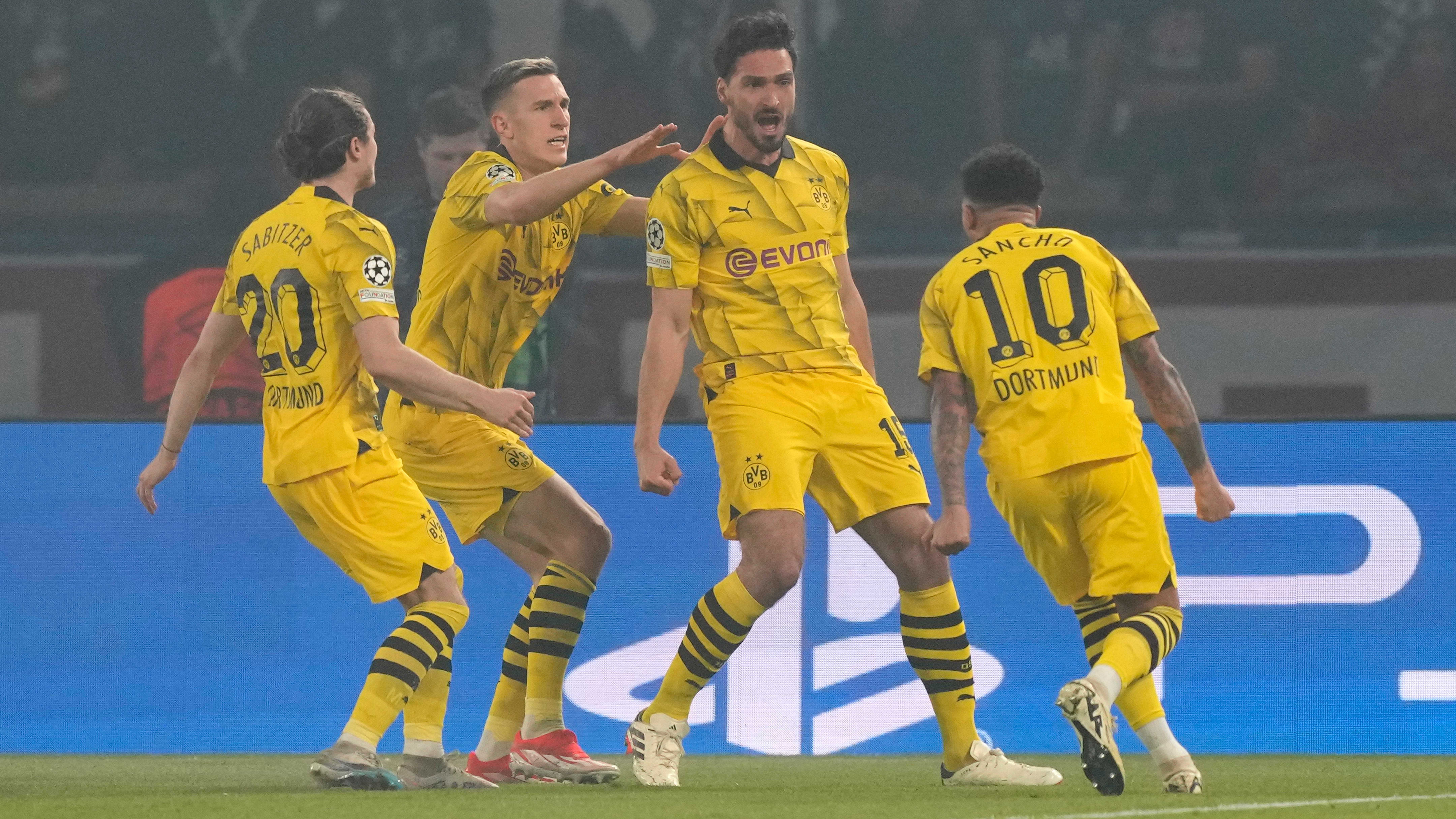 Mats Hummels, second right, celebrates with his team-mates (Frank Augstein/AP)