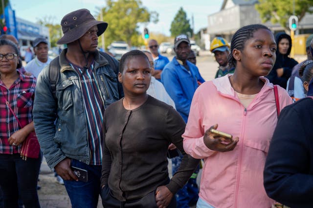 Onlookers gather near the site of the building collapse in George, South Africa