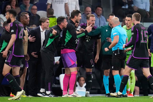 Bayern's players remonstrate with Marciniak at the end of the match at the Bernabeu
