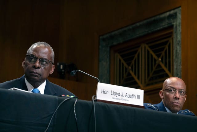 Secretary of Defence Lloyd Austin, left, and chairman of the Joint Chiefs of Staff Air Force General CQ Brown, right, attend a hearing of the Senate Appropriations Committee Subcommittee on Defence on Capitol Hill, Wednesday in Washington