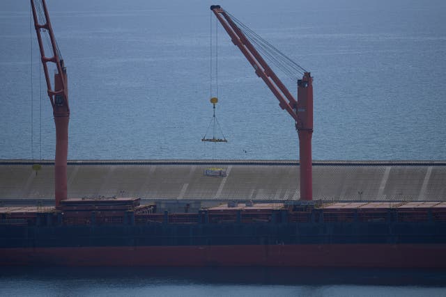 A crane loads food aid onto a ship in Cyprus 