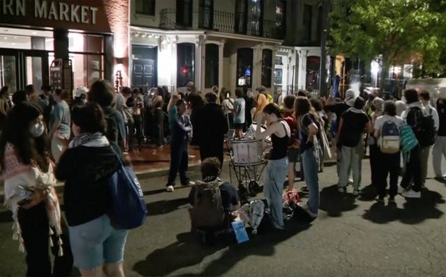 In this grab taken from video, protesters protesting the Israel-Hamas war stand outside near the campus of George Washington University, in Washington 