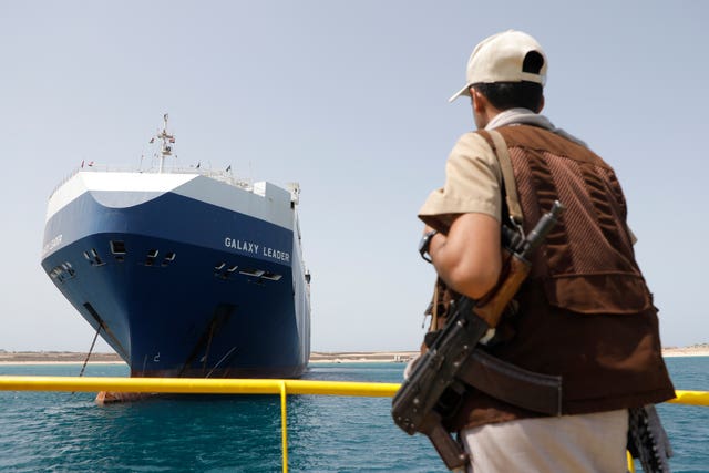 A Houthi soldier stands alert in front of the Israeli Galaxy ship which was seized by the Houthis, in the port of Saleef, near Hodeidah, Yemen 