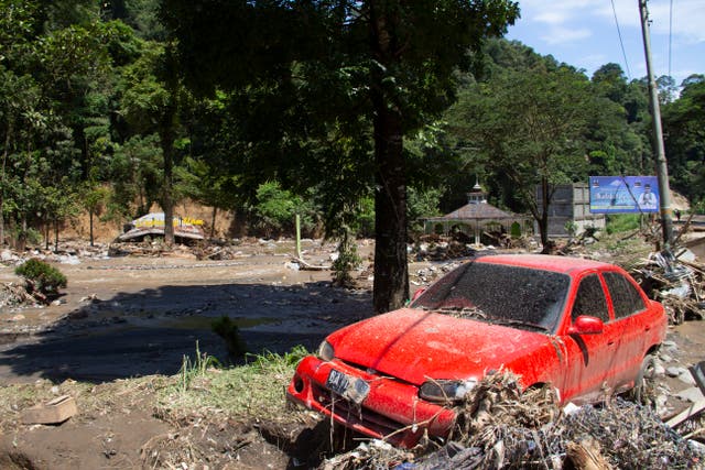 The wreckage of a car lies in a village affected by a flash flood in Tanah Datar, West Sumatra, Indonesia