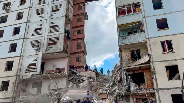 Russian emergency services work at the scene of a partially collapsed block of flats authorities said was hit during an attack by Ukrainian shelling in Belgorod, Russia 