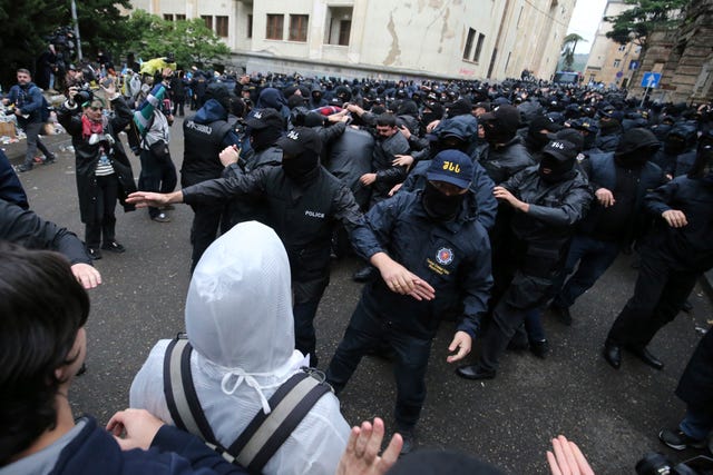 Police block demonstrators near the parliament building during an opposition protest against 'the Russian law' in the centre of Tbilisi, Georgia 