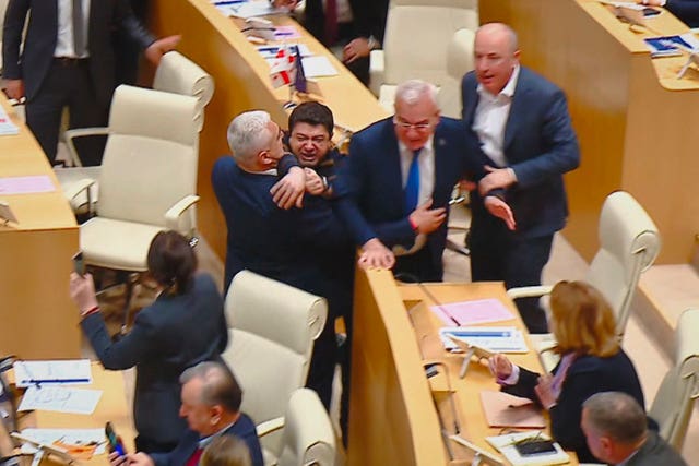 This photo taken from video shows Georgian legislators fighting during a parliament session in Tbilisi 