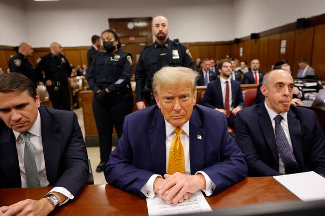 Former US president Donald Trump sits in the courtroom with lawyers Todd Blanche, left, and Emil Bove at Manhattan Criminal Court before his trial in New York