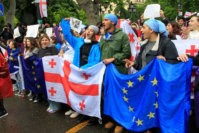 Demonstrators attend a protest near the parliament building in Tbilisi, Georgia