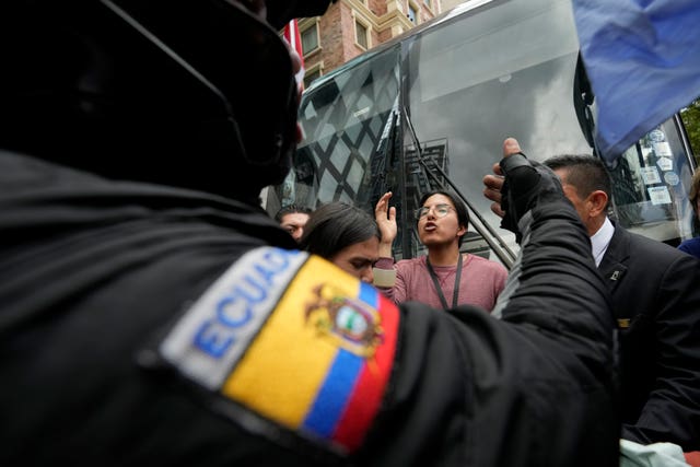 A protester argues with a police officer in Quito, Ecuador