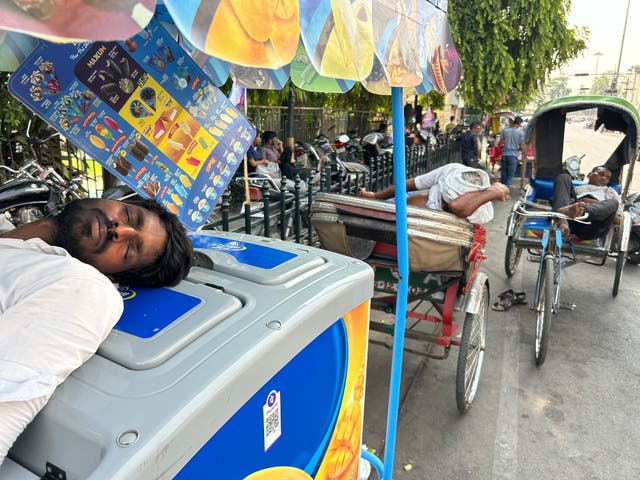 An ice cream vendor and rickshaw pullers sleep as severe heat grips Lucknow in India