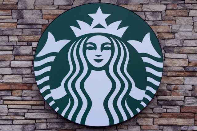 A Starbucks mermaid logo sign is displayed on a store in the US