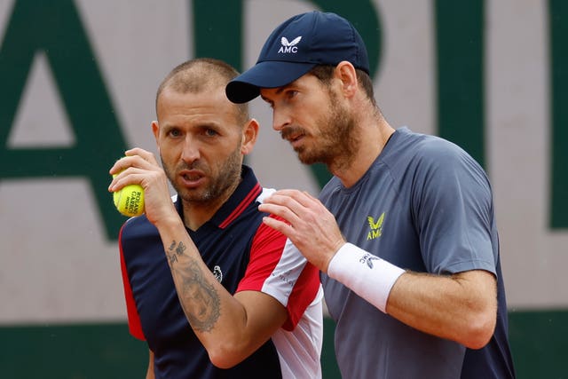 Dan Evans talks to Andy Murray on court at the French Open