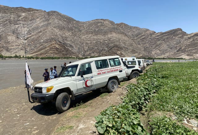 Health worker vehicles near the site of the sunken boat