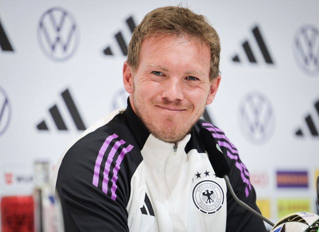 Julian Nagelsmann smiles at a press conference 