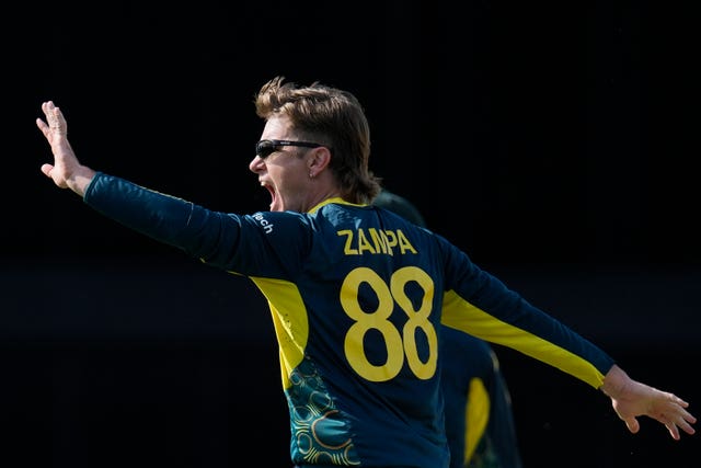 Australia’s Adam Zampa celebrates taking the wicket of Jos Buttler (Ricardo Mazalan/AP)