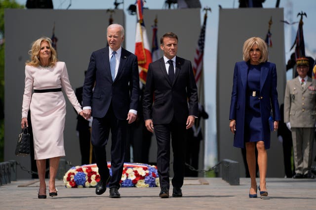 Joe Biden, his wife and the Macrons stand to attention before the Tomb of the Unknown Soldier