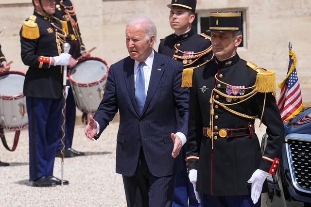 Joe Biden is escorted by a general