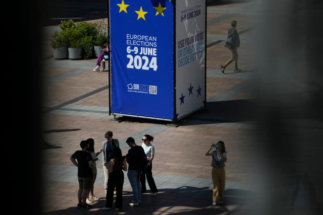 People stand on the outside esplanade during a voting night event at the European Parliament in Brussels