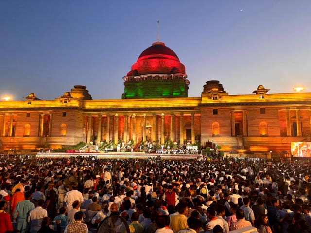 People watch as Narendra Modi is sworn-in as the Prime Minister of India by President Draupadi Murmu at the Rashtrapati Bhawan, in New Delhi, India