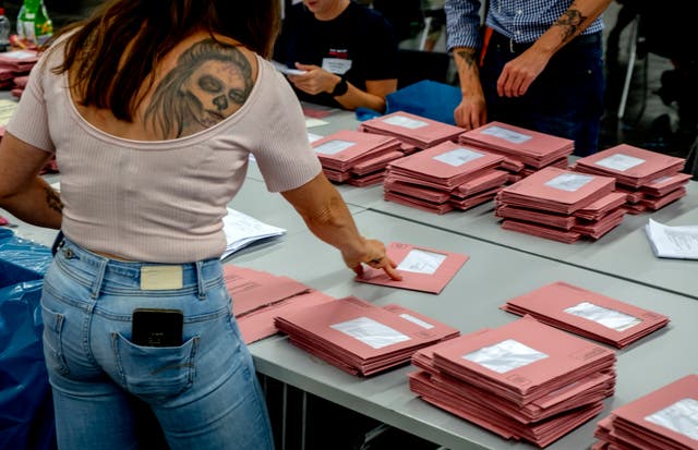 Helpers work on the postal ballots for the European elections in a hall of the fair sound in Frankfurt, Germany