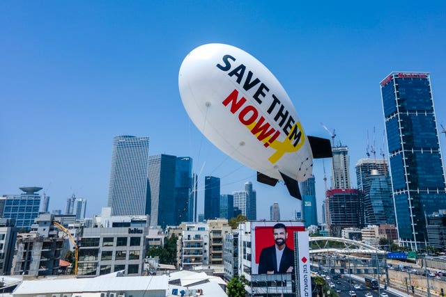 Family and friends of the remaining hostages held in the Gaza Strip by the Hamas militant group launch a small blimp calling for their release in Tel Aviv, Israel