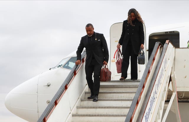 Malawi vice president Saulos Chilima, left, and his wife Mary disembark from a plane upon his return from South Korea in Lillongwe on Sunday, June 9 