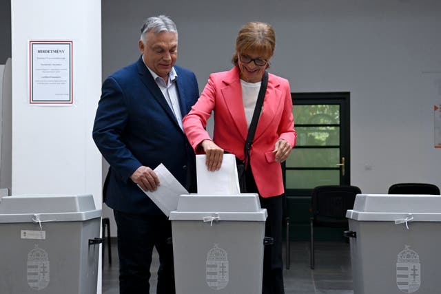 Viktor Orban and his wife post votes into ballot box