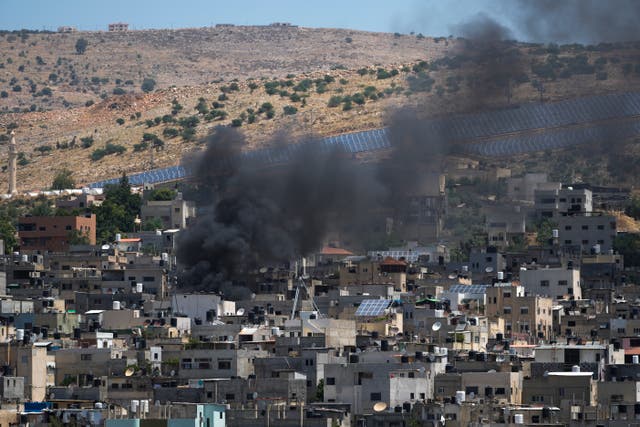 Smoke rises in the Palestinians Al Fara’a refugee camp in the occupied West Bank following an Israeli military raid