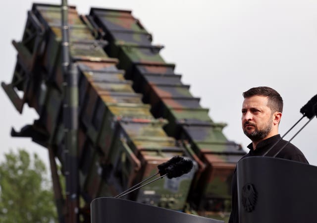 President Volodymyr Zelensky stands in front of a Patriot air defence missile system