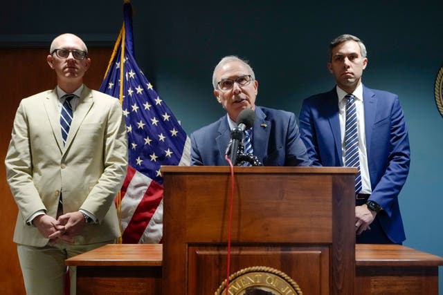 Special counsel David Weiss, centre, accompanied by federal prosecutors Derek Hines and Leo Wise, speaks during a news conference