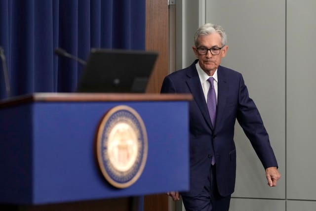 Federal Reserve chairman Jerome Powell walks towards a lectern