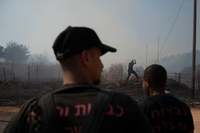 Israel Palestinians LebanonIsraeli firefighters work to extinguish a fire burning in an area near the border with Lebanon, in Safed, northern Israel