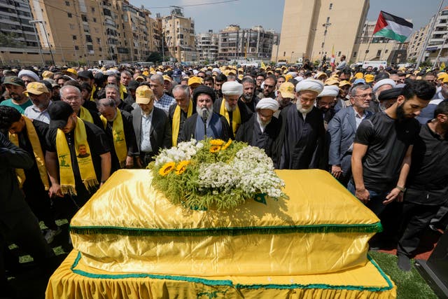 People pray over the coffin of senior Hezbollah commander Taleb Sami Abdullah who was killed on Tuesday by an Israeli strike in south Lebanon