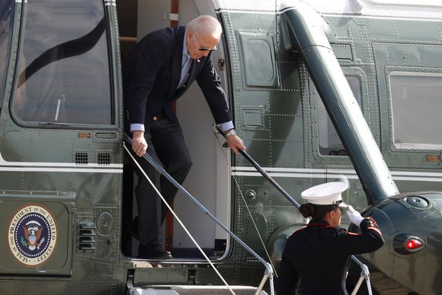 President Joe Biden is saluted as he exits the Marine One helicopter