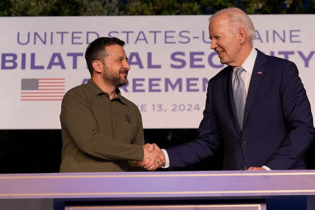 US President Joe Biden and Ukrainian President Volodymyr Zelensky shaking hands after signing a security agreement on the sidelines of the G7 meeting in Italy