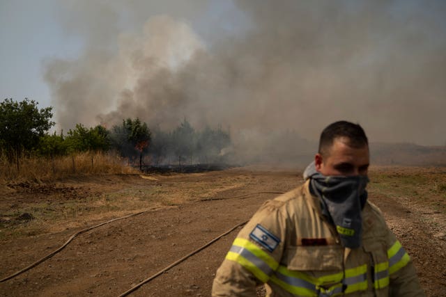 A firefighter near a fire burning in the Israeli-controlled Golan Heights