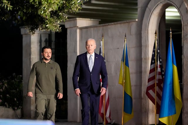 President Joe Biden and Ukrainian President Volodymyr Zelensky arrive to sign a bilateral security agreement on the sidelines of the G7 in Savelletri, Italy