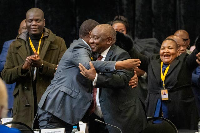 African National Congress politicians and South African president Cyril Ramaphosa react after he is re-elected as leader of the country in Cape Town, South Africa