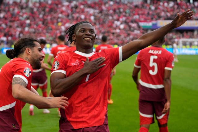 Breel Embolo celebrates with his arms outstretched after scoring Switzerland's third goal against Hungary 