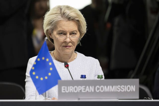Ursula von der Leyen, behind lectern showing EU flag
