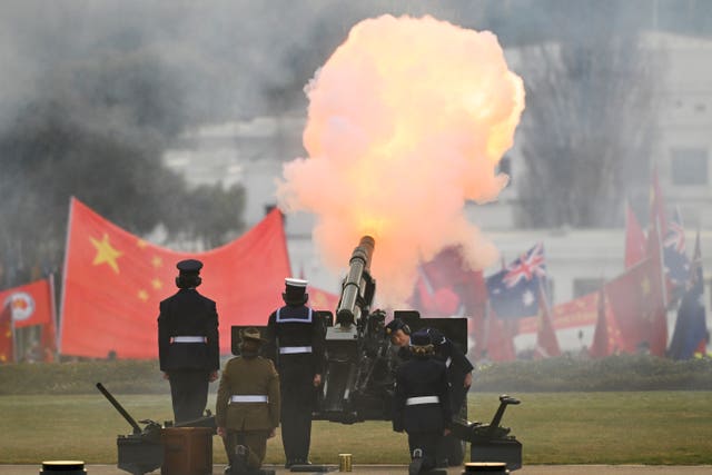 A gun salute as Chinese Premier Li Qiang inspects a guard of honor outside Parliament House in Canberra