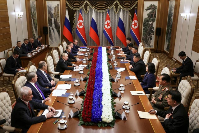 The two delegations face each other across the table