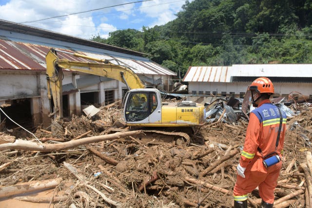 Rescuers clear debris in a flood-affected area in Sishui Township of Pingyuan County