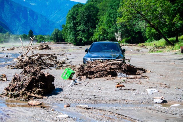 A car stuck in the mud at Sorte village after a landslide caused by the bad weather and heavy rain in the Misox valley, in Lostallo, southern Switzerland 