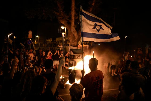People taking part in a protest against the Israeli government