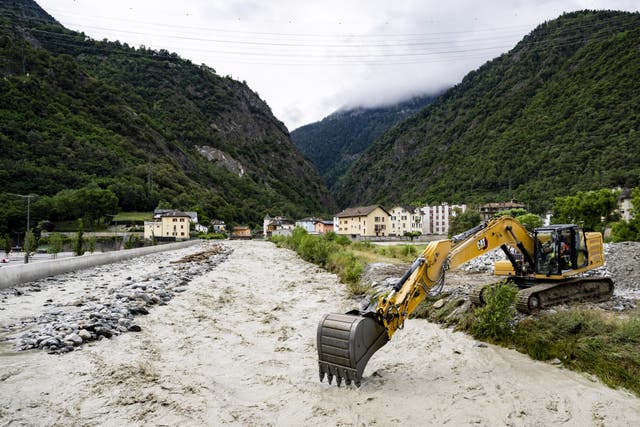 An excavator removes stones from the bed of the Navizence River, which flows into the Rhone, in Chippis, canton Valais, Switzerland