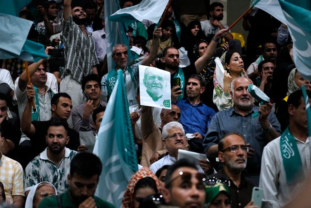 Supporters of Mr Pezeshkian attend a campaign meeting in Tehran 